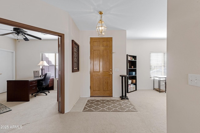 foyer featuring a wealth of natural light and light carpet