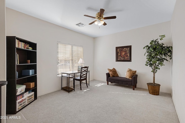 sitting room with ceiling fan and carpet