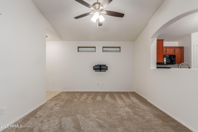 12132 W Caribbean Ln, El Mirage, AZ 85335 - spare room with lofted ceiling, a ceiling fan, light carpet, and arched walkways