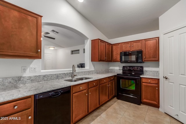 12132 W Caribbean Ln, El Mirage, AZ 85335 - kitchen featuring black appliances, lofted ceiling, light tile patterned flooring, brown cabinets, and light stone counters