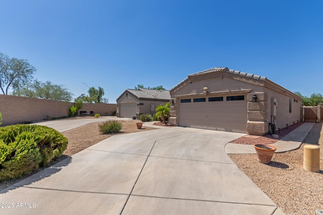 12132 W Caribbean Ln, El Mirage, AZ 85335 - view of front of house featuring concrete driveway, stucco siding, and a garage