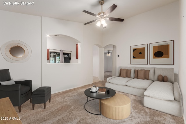 12132 W Caribbean Ln, El Mirage, AZ 85335 - living room with ceiling fan, arched walkways, and carpet flooring