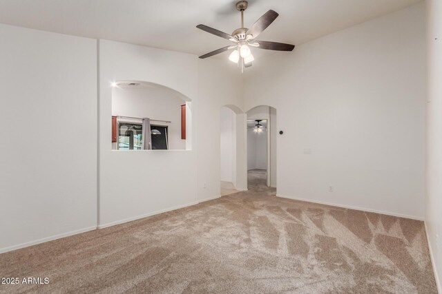 12132 W Caribbean Ln, El Mirage, AZ 85335 - carpeted spare room featuring arched walkways and a ceiling fan