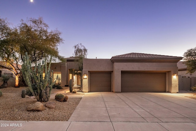 pueblo-style home featuring a garage