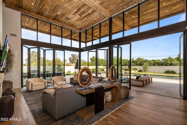 sunroom featuring a healthy amount of sunlight and wooden ceiling