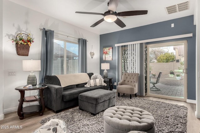 living room featuring ceiling fan and light hardwood / wood-style flooring