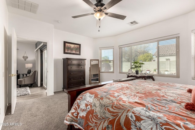 bedroom with ceiling fan and light colored carpet