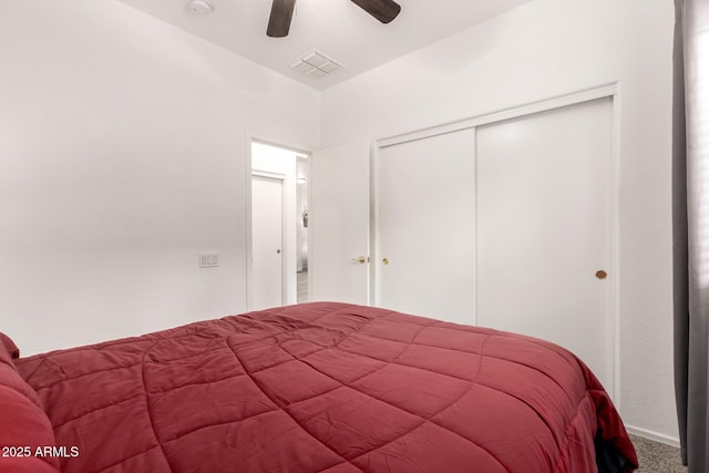 carpeted bedroom featuring ceiling fan and a closet