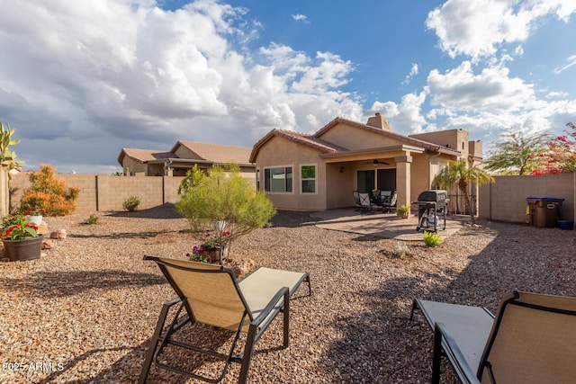 back of property with ceiling fan and a patio area