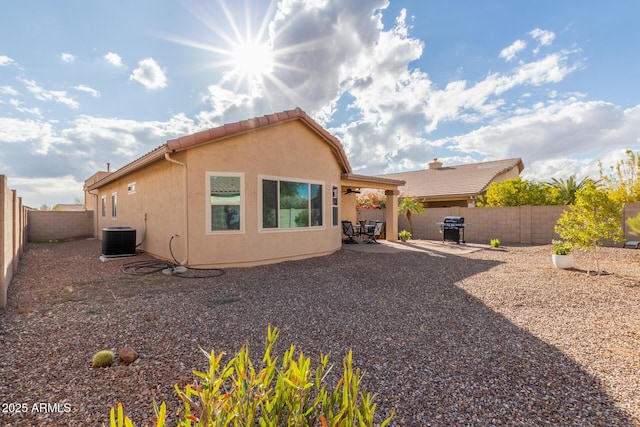 rear view of house with a patio and cooling unit