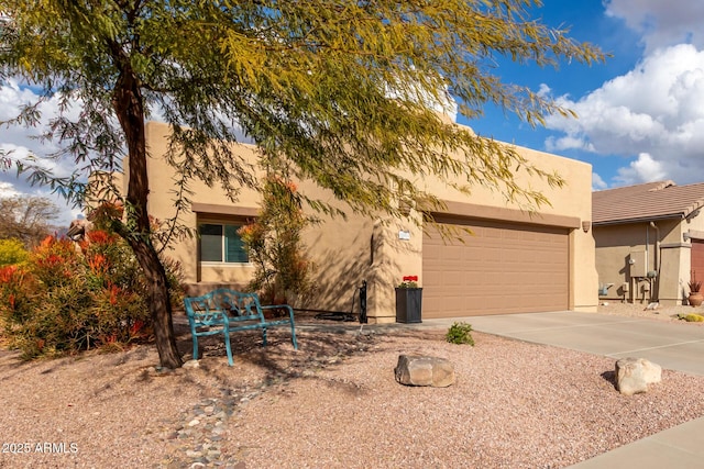 pueblo-style home with a garage