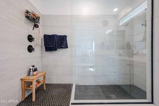 bathroom featuring a tile shower and tile patterned floors