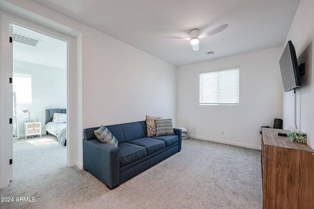 carpeted living room featuring ceiling fan and plenty of natural light