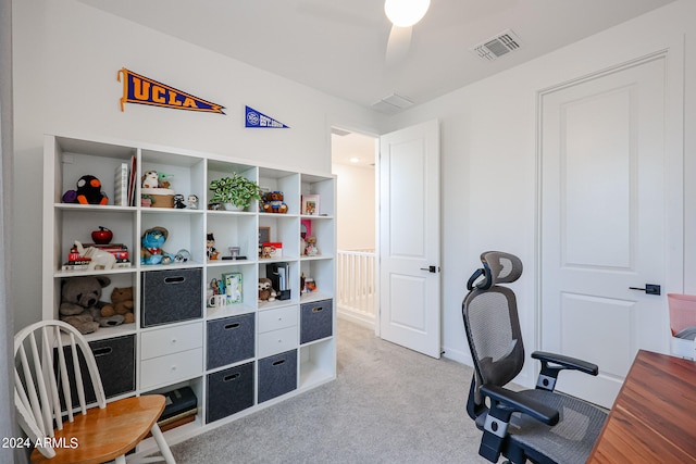 home office featuring ceiling fan and light carpet