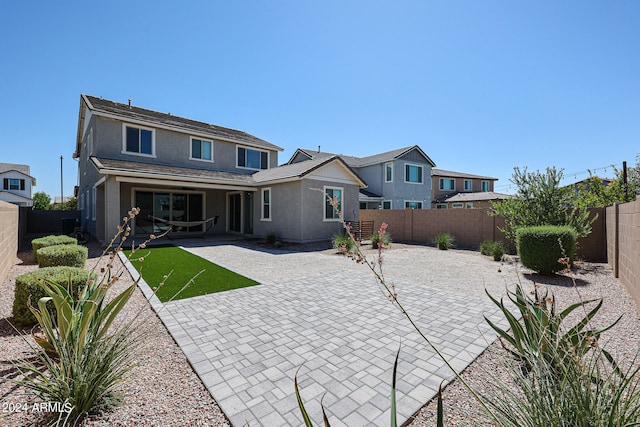 back of property with a patio