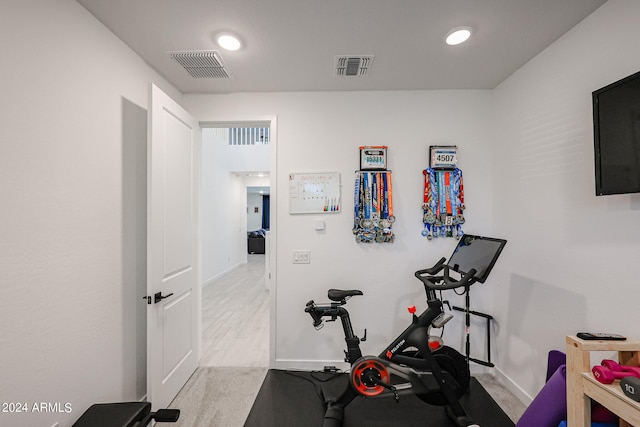 workout room with light colored carpet