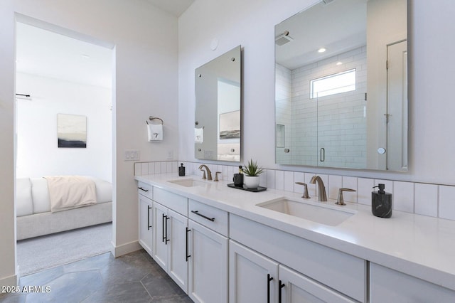 full bath featuring double vanity, a stall shower, backsplash, and a sink