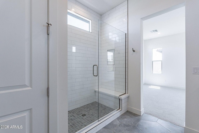 full bath with tile patterned floors, visible vents, baseboards, and a stall shower