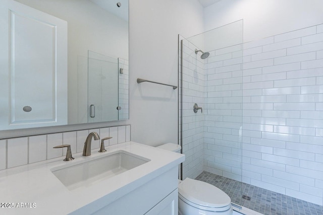 full bath with vanity, toilet, and tiled shower