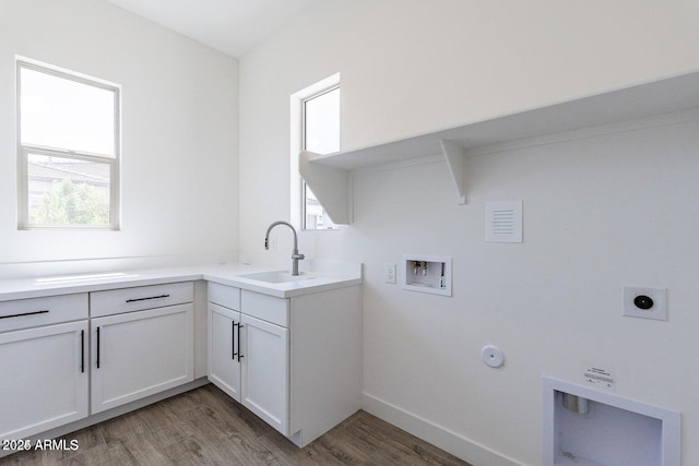 laundry area featuring hookup for a washing machine, hookup for an electric dryer, a sink, hookup for a gas dryer, and a wealth of natural light