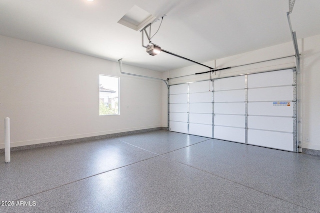 garage featuring a garage door opener and baseboards