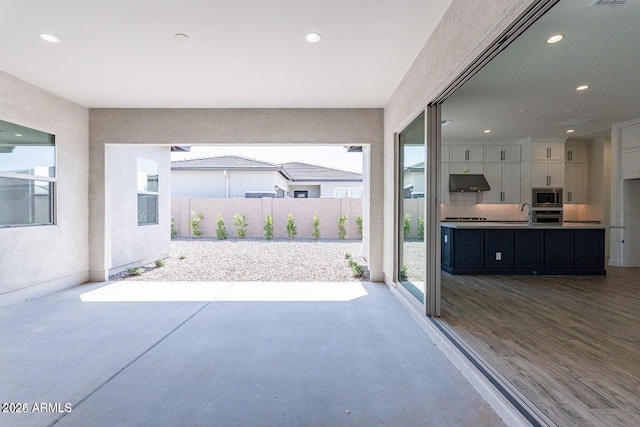 view of patio / terrace featuring visible vents and fence