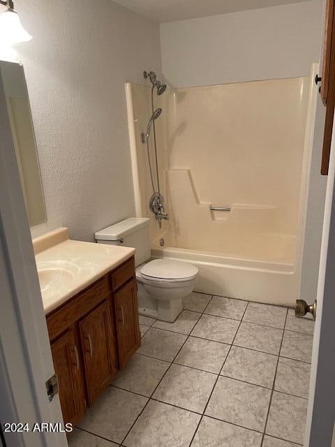 full bathroom with shower / bathtub combination, tile patterned floors, and vanity