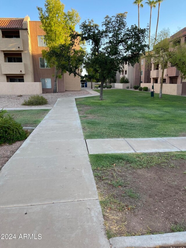 view of property's community with a lawn