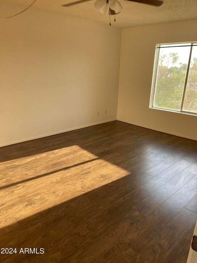 unfurnished room with a textured ceiling, ceiling fan, and hardwood / wood-style floors