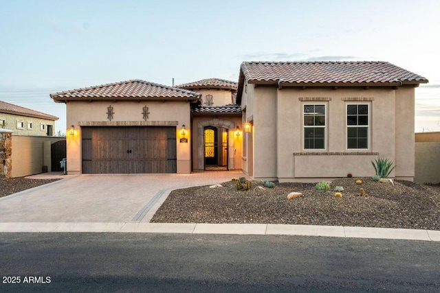 mediterranean / spanish house featuring a garage