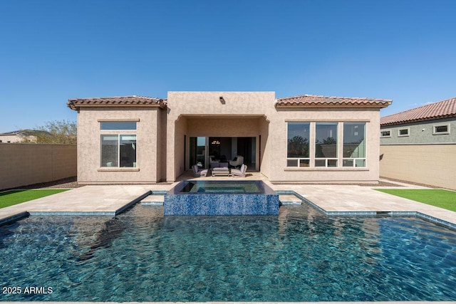 back of house with a patio and a pool with hot tub