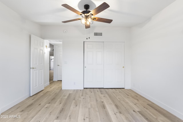 unfurnished bedroom with ceiling fan, a closet, and light hardwood / wood-style floors