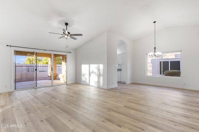 unfurnished living room with ceiling fan with notable chandelier, light hardwood / wood-style flooring, and lofted ceiling