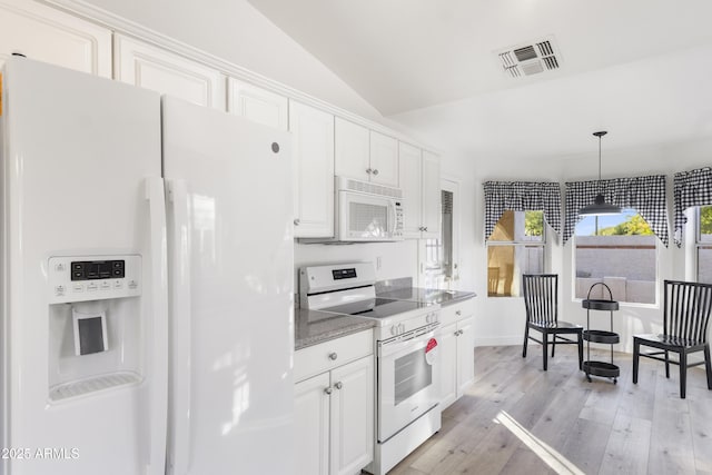 kitchen featuring white appliances, light hardwood / wood-style floors, white cabinetry, hanging light fixtures, and lofted ceiling