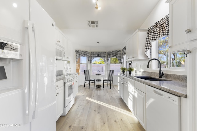 kitchen featuring pendant lighting, white appliances, white cabinetry, and sink