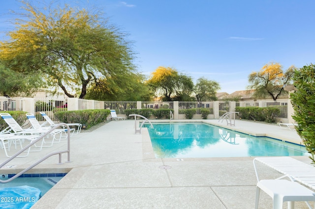 view of swimming pool featuring a patio area