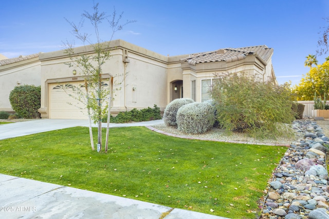 mediterranean / spanish-style house with a garage and a front lawn