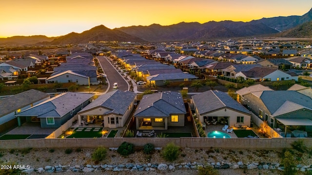 aerial view at dusk featuring a mountain view