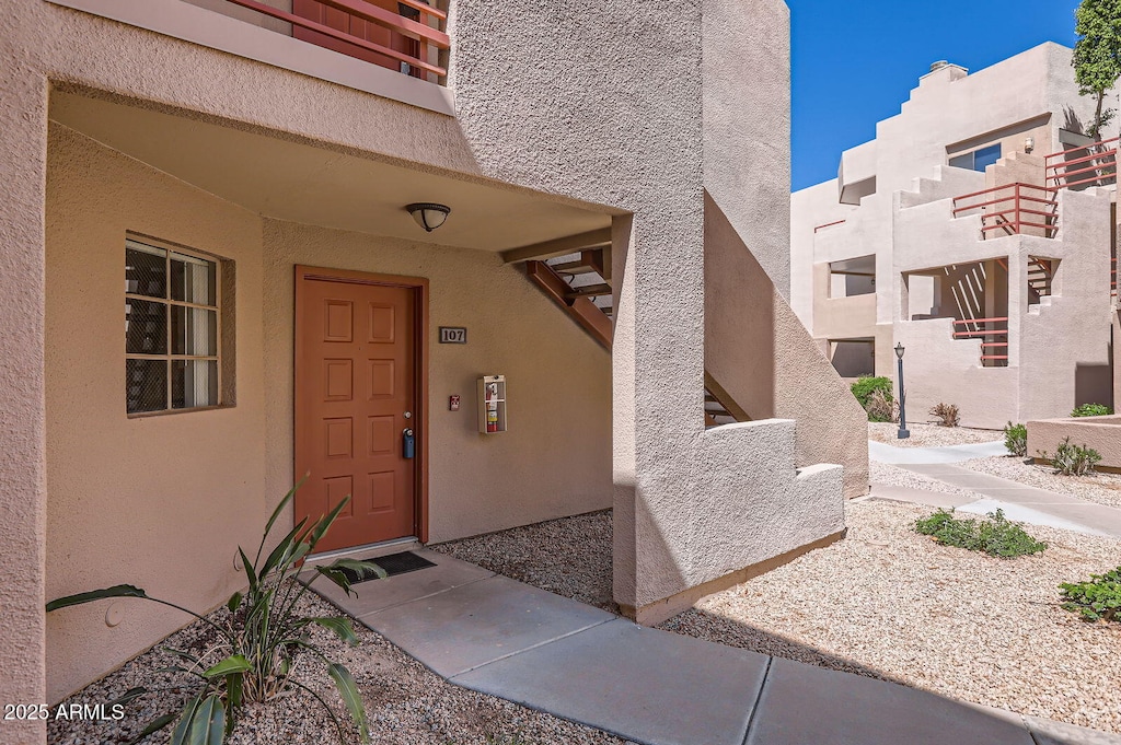 view of exterior entry featuring stucco siding