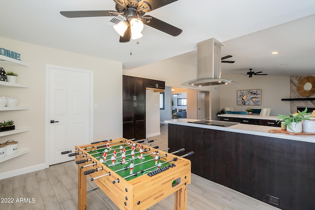 recreation room with wood finish floors, baseboards, lofted ceiling, and ceiling fan