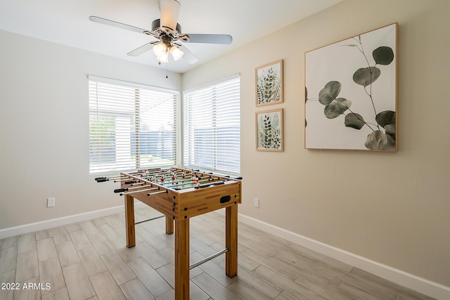 playroom with light wood-type flooring, baseboards, and ceiling fan