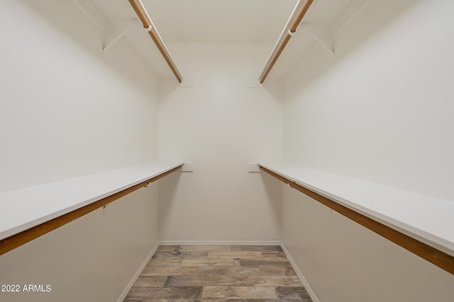 walk in closet featuring light wood finished floors