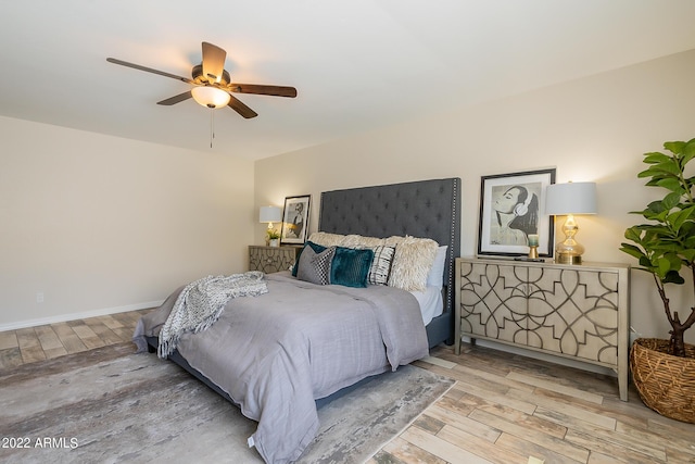 bedroom with baseboards, a ceiling fan, and wood finished floors