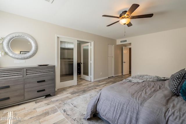 bedroom with visible vents, light wood-style flooring, french doors, baseboards, and ceiling fan