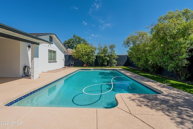 view of swimming pool featuring a fenced in pool, a patio, and a fenced backyard