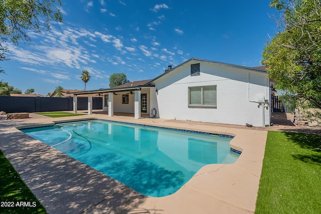 view of swimming pool with a fenced backyard, a fenced in pool, ceiling fan, and a patio area