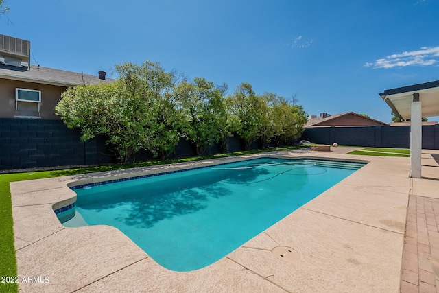 view of swimming pool featuring a patio, central AC unit, a fenced backyard, and a fenced in pool