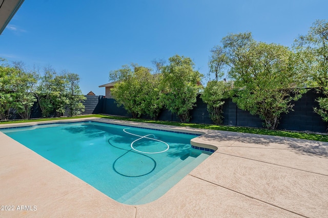 view of swimming pool with a patio area, a fenced in pool, and a fenced backyard