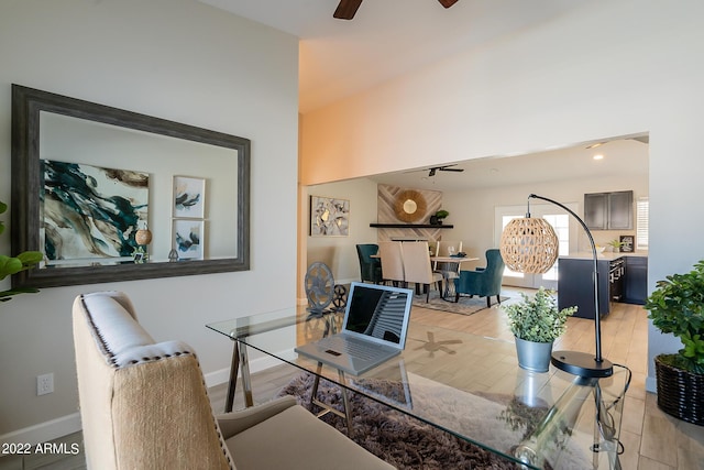 office area with light wood-style flooring, ceiling fan with notable chandelier, and baseboards