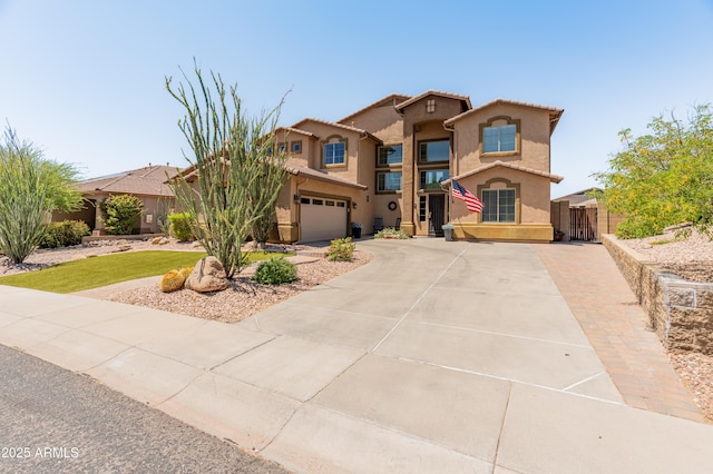 4418 W Yoosooni Dr, New River, AZ 85087 - mediterranean / spanish-style house featuring driveway, stucco siding, and an attached garage